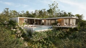 Casa OM in Playa Carrillo, Costa Rica - a modern luxury home surrounded by tropical greenery. Features include minimalist architecture, glass walls, an infinity pool, and elevated terrace for seamless indoor-outdoor living. Ideal for a secluded, nature-immersed retreat